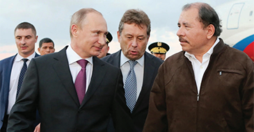 Russian President Vladimir Putin talks with Nicaraguan President Daniel Ortega at Augusto C. Sandino Airport in Managua, July 11, 2014